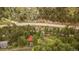 High angle of rustic cabin nestled in wooded area next to a winding road and a stream at 35106 Boulder Canyon Dr, Boulder, CO 80302
