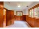 Well lit bedroom with natural light and wood paneled walls and an open door at 35106 Boulder Canyon Dr, Boulder, CO 80302