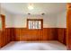 Bright bedroom with wood paneled walls and a view to the outdoors through the large windows at 35106 Boulder Canyon Dr, Boulder, CO 80302