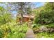 Lovely wooded cabin featuring a wooden walkway and lots of beautiful greenery at 35106 Boulder Canyon Dr, Boulder, CO 80302