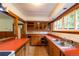 Well-lit kitchen featuring classic wood cabinets, neutral tile, and bright red countertops at 35106 Boulder Canyon Dr, Boulder, CO 80302