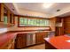 Functional kitchen with wood cabinets, tiled backsplash, and red countertops at 35106 Boulder Canyon Dr, Boulder, CO 80302