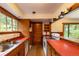 Classic kitchen with red countertops, wood cabinets, and a view overlooking nature at 35106 Boulder Canyon Dr, Boulder, CO 80302