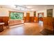 Bright living room with hardwood floors, wood paneling, and a large window overlooking nature at 35106 Boulder Canyon Dr, Boulder, CO 80302