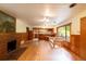 Open-concept living room with hardwood floors, fireplace, and a view into the adjacent kitchen at 35106 Boulder Canyon Dr, Boulder, CO 80302