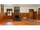 Cozy living room featuring a brick fireplace, wood-paneled walls, and hardwood floors at 35106 Boulder Canyon Dr, Boulder, CO 80302