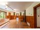 Spacious living room featuring hardwood floors, a brick fireplace, and wood-paneled walls at 35106 Boulder Canyon Dr, Boulder, CO 80302