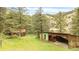 A full, green and lush lot featuring a wooden cabin and an outbuilding at 35106 Boulder Canyon Dr, Boulder, CO 80302