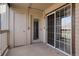 Private outdoor balcony featuring glass doors and storage area at 9212 E Arbor Cir # E, Englewood, CO 80111