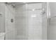 Bathroom featuring a glass enclosed shower with white tile and chrome fixtures at 9212 E Arbor Cir # E, Englewood, CO 80111