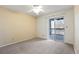 Bright bedroom with a fan and sliding glass doors to a balcony at 9212 E Arbor Cir # E, Englewood, CO 80111