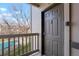 Apartment entryway with gray door, digital keypad, and view of the community pool from the balcony at 9212 E Arbor Cir # E, Englewood, CO 80111