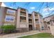 Attractive three-story condominium features private balconies and a mix of stone and wood siding at 9212 E Arbor Cir # E, Englewood, CO 80111