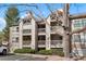 Charming condo exterior with multiple balconies and well-maintained landscaping on a sunny day at 9212 E Arbor Cir # E, Englewood, CO 80111