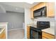 Modern kitchen with stainless steel microwave and oven, paired with light wooden cabinets and countertops at 9212 E Arbor Cir # E, Englewood, CO 80111