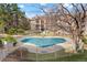Relaxing view of the community pool surrounded by lush greenery and residential buildings at 9212 E Arbor Cir # E, Englewood, CO 80111