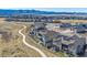 Stunning aerial view of a modern community, highlighting the well-maintained homes, walking paths, and scenic mountain backdrop at 8016 Gore Creek Ln, Littleton, CO 80125