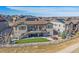 Expansive backyard with a covered patio, fenced yard, and solar panels on the roof at 8016 Gore Creek Ln, Littleton, CO 80125