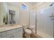 Bathroom with shower stall, toilet, vanity, and modern finishes at 8016 Gore Creek Ln, Littleton, CO 80125