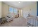 Adorable Bedroom with neutral colors, plush chair, and a cozy crib for a comfortable space at 8016 Gore Creek Ln, Littleton, CO 80125