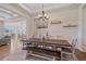 Open concept dining room with wood floors, stylish light fixture and views of living room and kitchen at 8016 Gore Creek Ln, Littleton, CO 80125