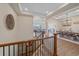 Elegant entryway with hardwood floors, staircase with iron railings, and views of the dining and living areas at 8016 Gore Creek Ln, Littleton, CO 80125