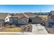 Charming single-story home featuring stone accents, a well-manicured lawn, and a two-car garage for comfortable living at 8016 Gore Creek Ln, Littleton, CO 80125