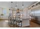 Stylish kitchen with white cabinets, stainless steel appliances, pendant lighting, and spacious island at 8016 Gore Creek Ln, Littleton, CO 80125