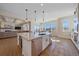 Open kitchen with island including dishwasher and sink, view to living room and informal dining area at 8016 Gore Creek Ln, Littleton, CO 80125