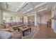 Open-concept living room with coffered ceilings that flows to the kitchen and dining area at 8016 Gore Creek Ln, Littleton, CO 80125