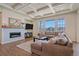 Spacious living room featuring coffered ceilings, a fireplace, and large windows offering plenty of natural light at 8016 Gore Creek Ln, Littleton, CO 80125