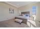 Spacious main bedroom with a wooden bed frame, carpet, and large windows for natural light at 8016 Gore Creek Ln, Littleton, CO 80125