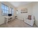 Sunlit home office with large windows, desk area, and comfortable chair for a productive workspace at 8016 Gore Creek Ln, Littleton, CO 80125