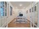 Well-lit home office featuring french doors, wood flooring, and rustic furniture for a cozy work space at 8016 Gore Creek Ln, Littleton, CO 80125