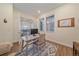 Home office with a desk, chair, patterned rug, and French doors at 8016 Gore Creek Ln, Littleton, CO 80125
