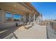Covered outdoor patio with comfortable seating, dining area, and scenic views at 8016 Gore Creek Ln, Littleton, CO 80125