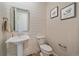 Stylish powder room with shiplap accent wall, pedestal sink, and modern fixtures at 8016 Gore Creek Ln, Littleton, CO 80125