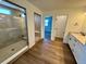 A luxurious bathroom featuring a glass-enclosed shower, double vanity, and modern fixtures at 245 Wooten Ave, Brighton, CO 80601