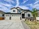 Charming two-story home featuring a three-car garage, stone accents, and a well-maintained front yard at 245 Wooten Ave, Brighton, CO 80601