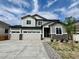 Charming two-story home featuring a three-car garage, stone accents, and well-manicured landscaping at 245 Wooten Ave, Brighton, CO 80601