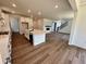 Open concept living area featuring hardwood floors, modern kitchen, and a cozy fireplace at 245 Wooten Ave, Brighton, CO 80601