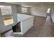 A modern stairwell with carpeted floors and natural light from large windows at 245 Wooten Ave, Brighton, CO 80601