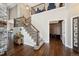 Grand foyer featuring hardwood floors, a stone accent wall, staircase, and an open view to the upper level at 5368 Wildcat Ct, Morrison, CO 80465