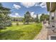 Spacious backyard features well-manicured lawn, stone patio, built-in grill, and peaceful views at 6435 Spotted Fawn Run, Littleton, CO 80125