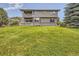 Expansive backyard with lush lawn, a multi-level deck, and mature trees at 6435 Spotted Fawn Run, Littleton, CO 80125