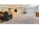 Spacious finished basement with a reclining chair, tv, and an open floor plan at 6435 Spotted Fawn Run, Littleton, CO 80125