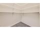 Walk-in closet with carpet and white shelving on all sides for organized storage at 6435 Spotted Fawn Run, Littleton, CO 80125