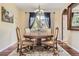 Elegant dining room with a round table, decorative rug, and natural light at 6435 Spotted Fawn Run, Littleton, CO 80125