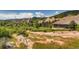 Picturesque hillside property nestled by large red rocks, mountains and scrub trees at 6435 Spotted Fawn Run, Littleton, CO 80125