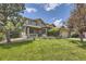 Spacious two-story home with mature trees, a well-kept lawn, and a charming exterior at 6435 Spotted Fawn Run, Littleton, CO 80125